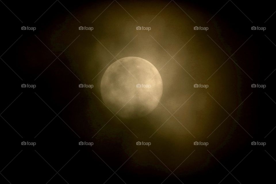 Full harvest moon in clouds