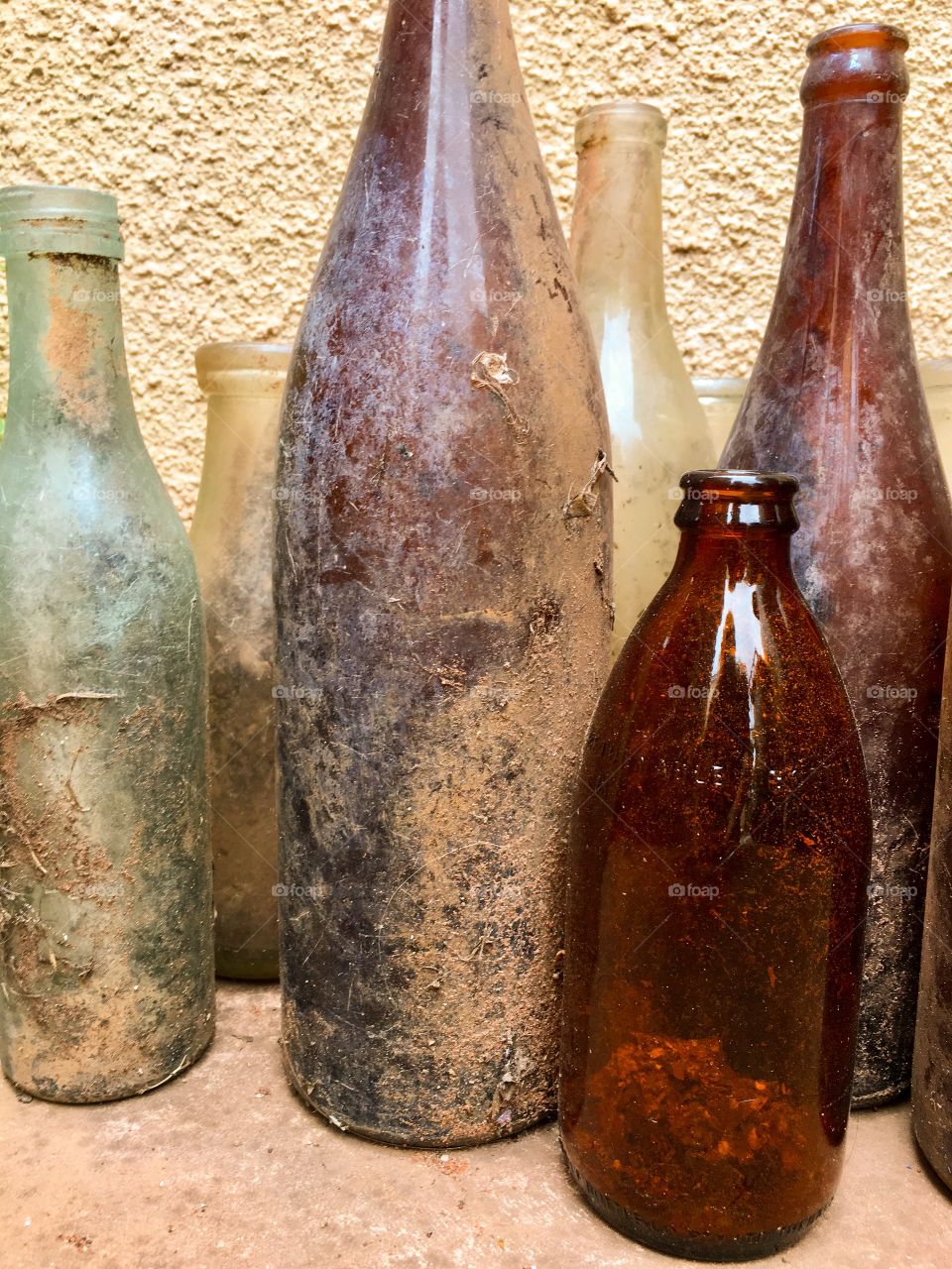 Assortment of old antique bottles upright freshly unearthed discovered. Great for background image 