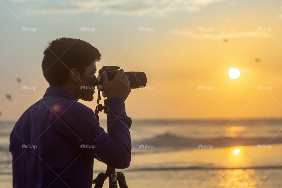 Photographer, sea and sunset