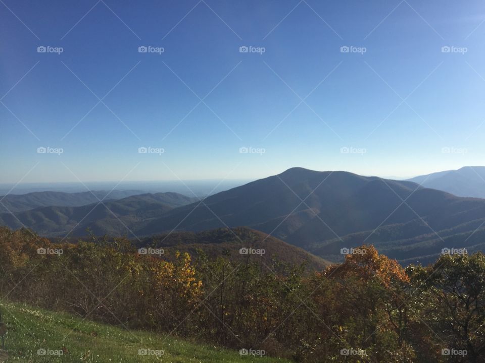 Great serene landscape of mountains with fresh blue sky and fall colors in the afternoon in September 