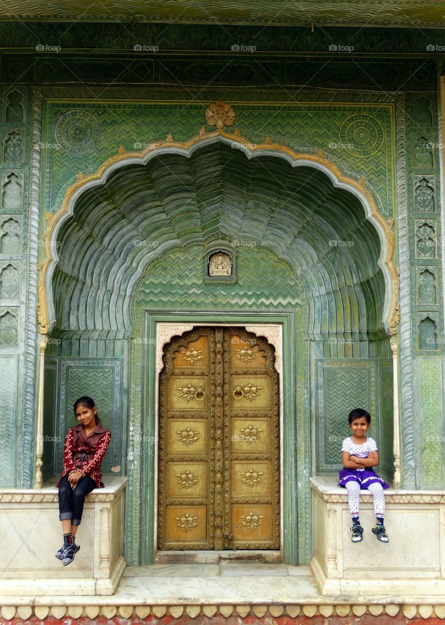 Two girls sitting at temple