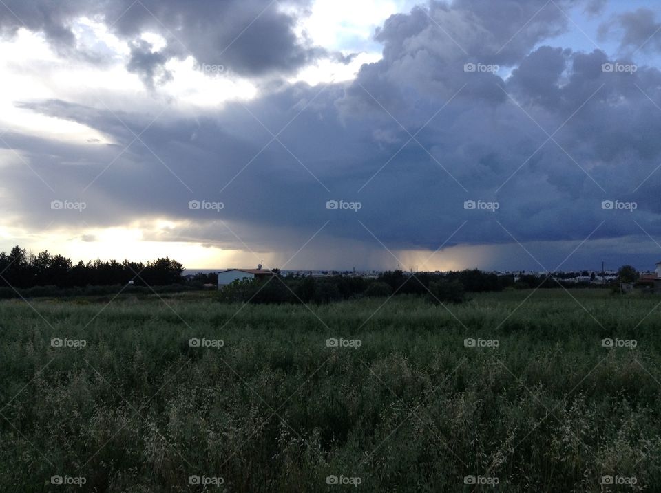 Storm clouds over the grassy land