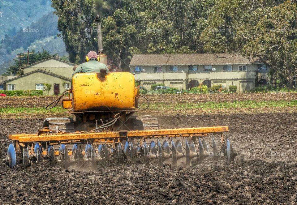 Farmer Riding A Tractor