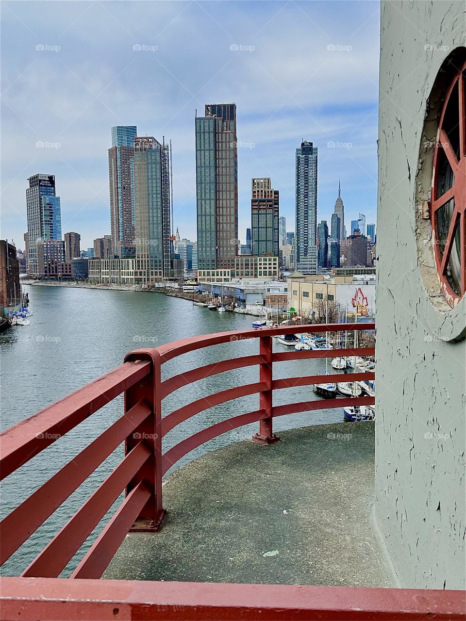 This is “Newtown Creek”, an ocean inlet of the “East River” seen from the central outpost of the “Pulaski Bridge” that connects “Greenpoint”, Bklyn to LIC. In the distance we see “Manhattan” incl. the “Empire State Bldg”. 2024. Hypnotic Productions
