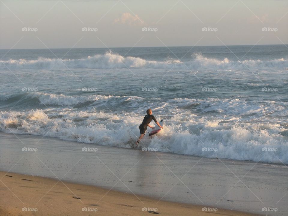 Surfer entering the Waves
