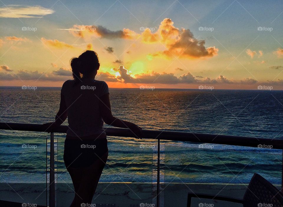 Rear view of woman looking at sunset