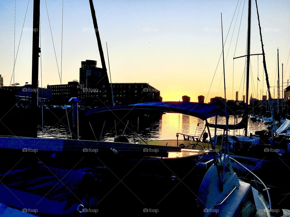 A dark silhouette of the Newtown Creek “harbor area” here in Newtown Creek in Long Island City, Queens, NY photographed from the shore on an evening at twilight time and upcoming nightfall in November 2021. Hypnotic Productions