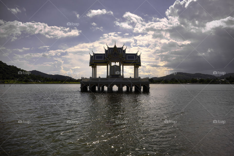 Thai Buddhist temple stupa in a middle of a lake