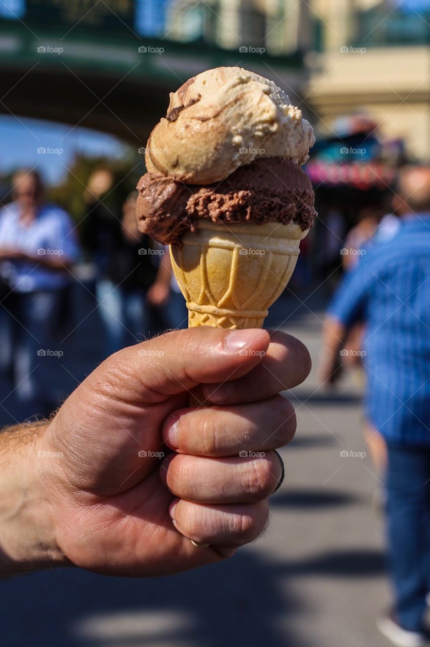Person's hand holding ice-cream