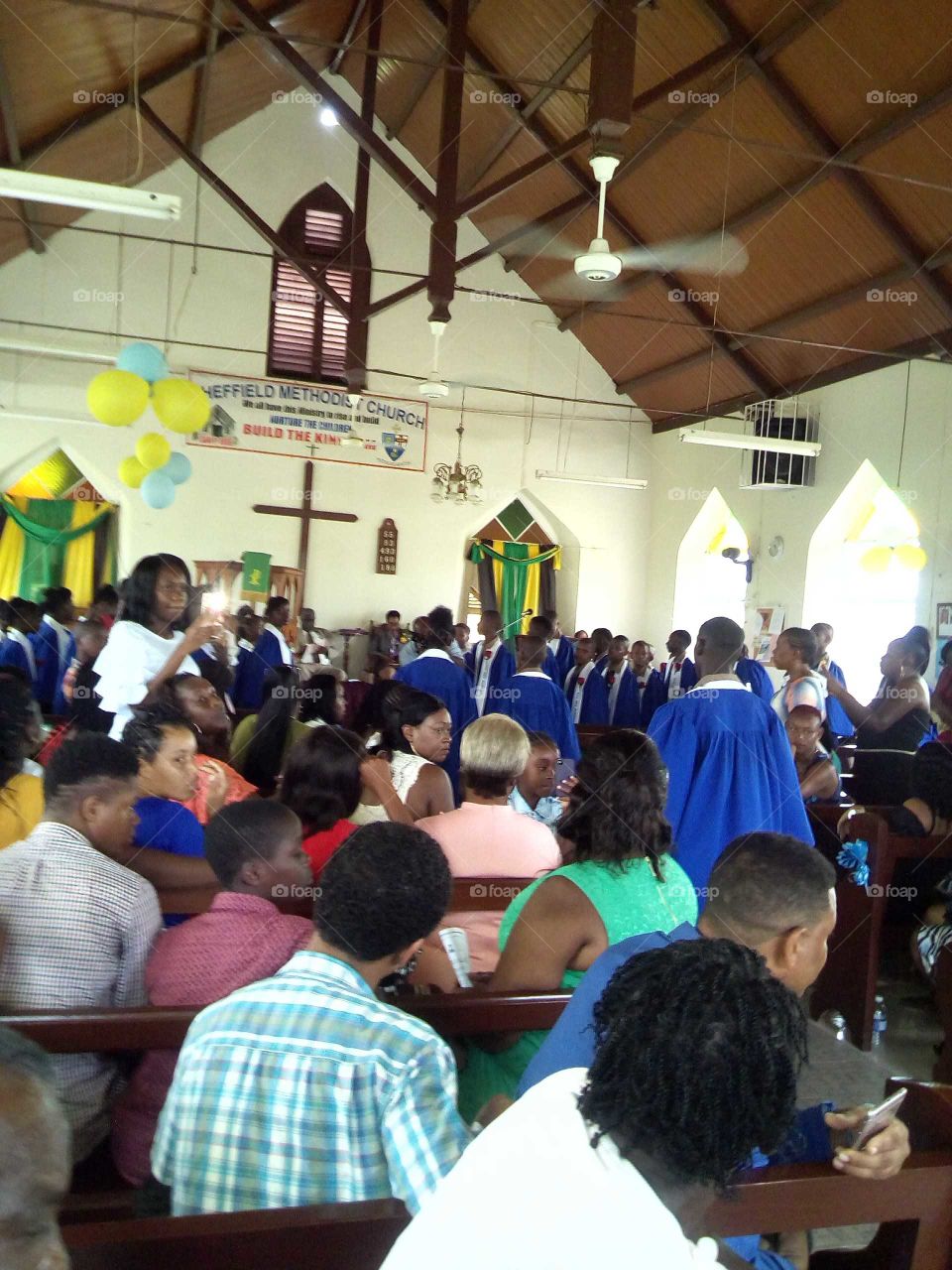 this is awesome picture with so many people just sitting down looking at there children