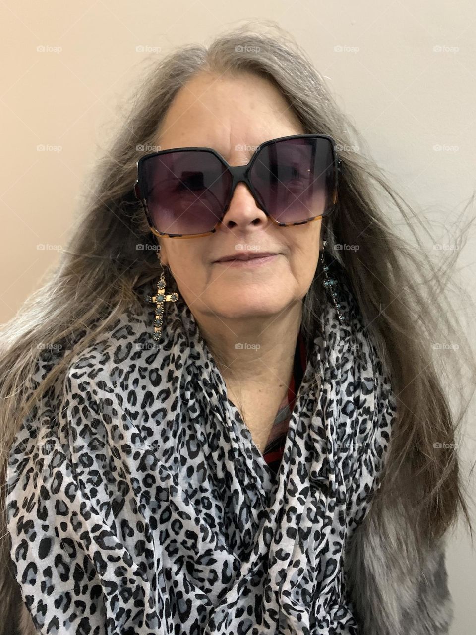 Stylish senior woman in sunglasses and statement earrings