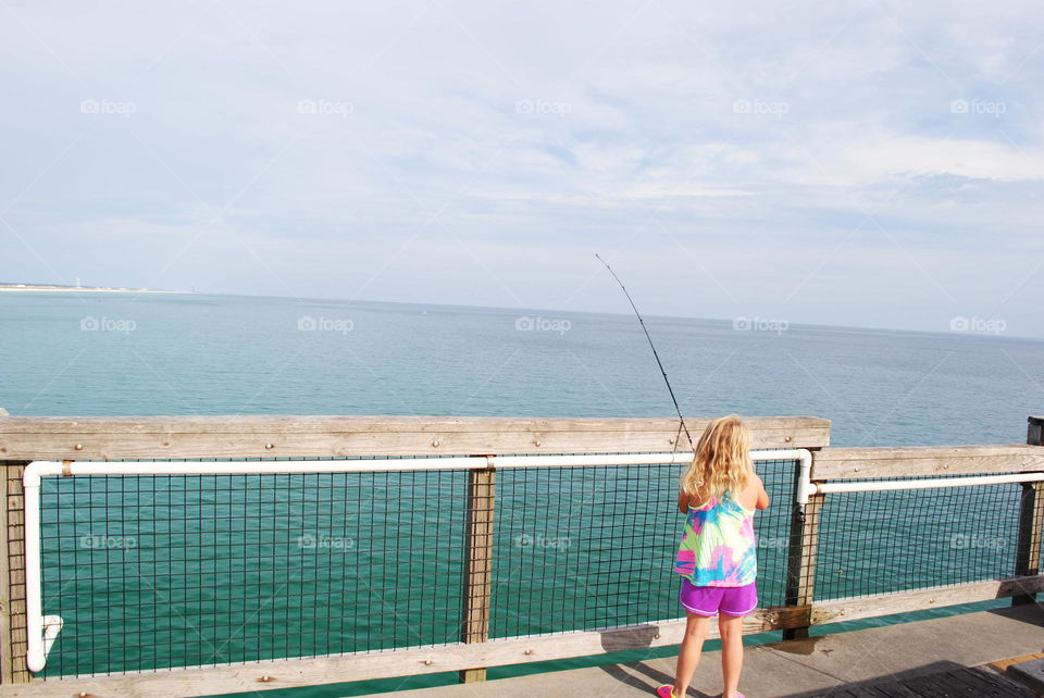 Little girl fishing in Navarre Beach, Fl