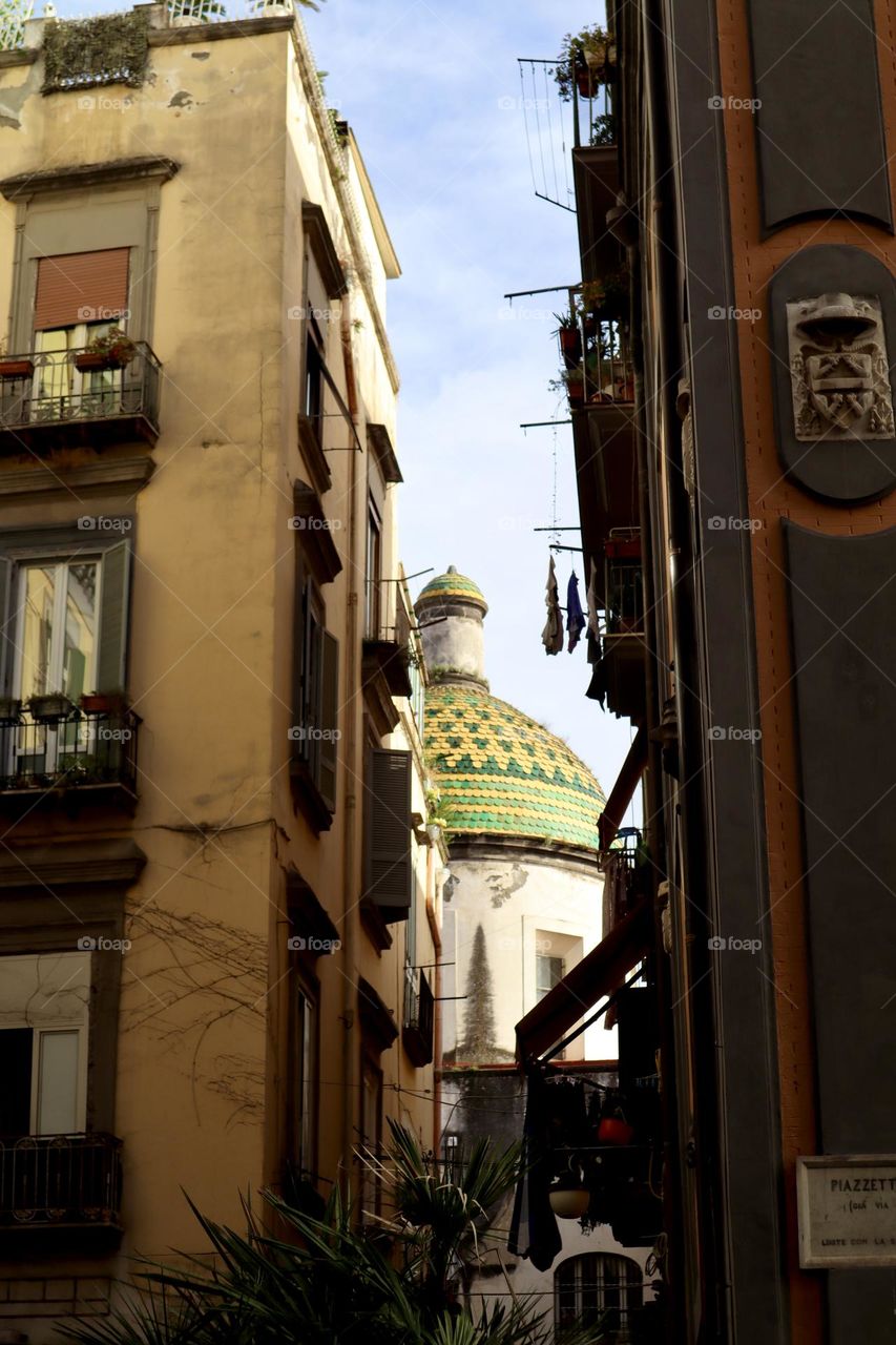 Green church roof between the buildings at Napoli