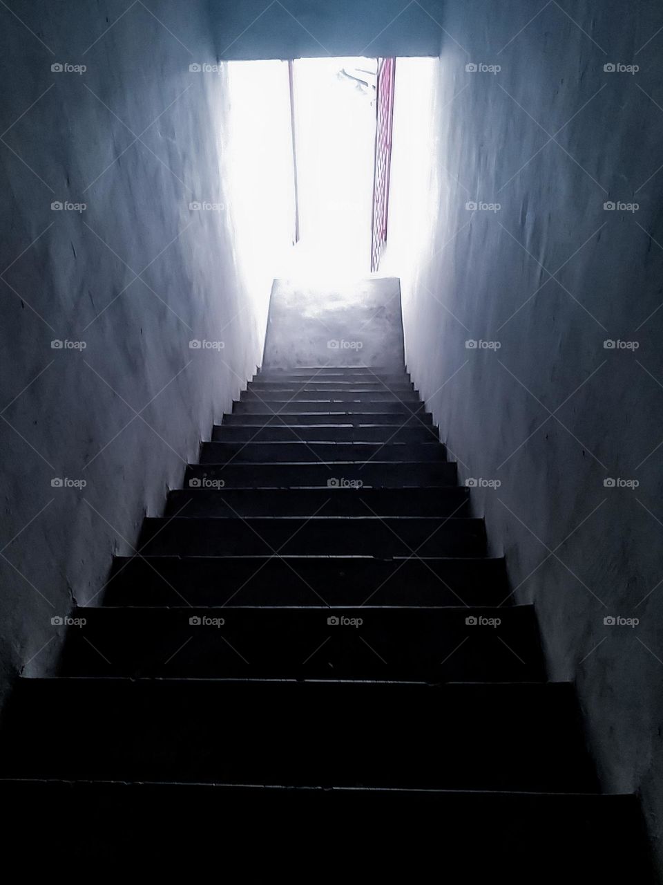 A tunnel with stairs towards the light