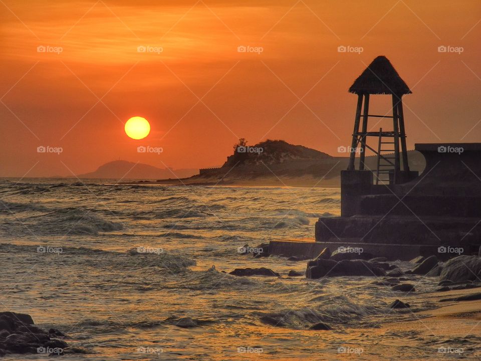 Watching tower on the beach.  Sunset time. 
