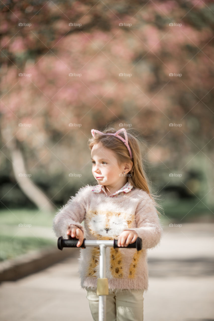 Cute Little girl in a blossom park