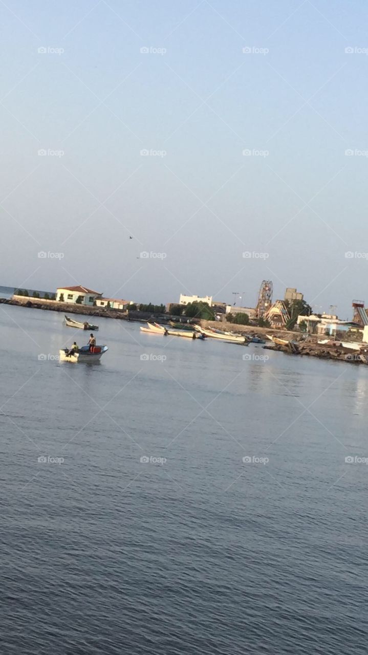 I took this picture when I was traveling to Aden. This picture can say a lot. The two men are fishermen’s , beautiful quite clear ocean. This place where most of the fishermen’s like to fish. 