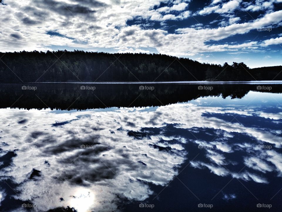 Forest lake in norway, beautiful sky reflection