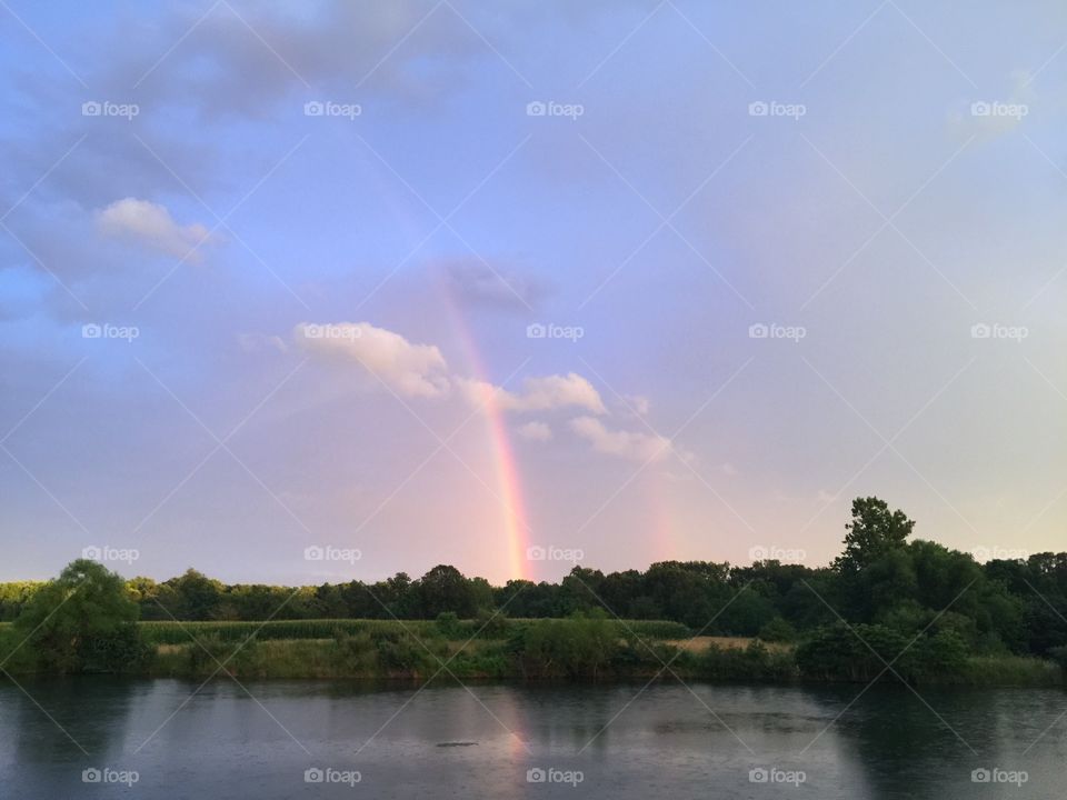 Double rainbow over pond