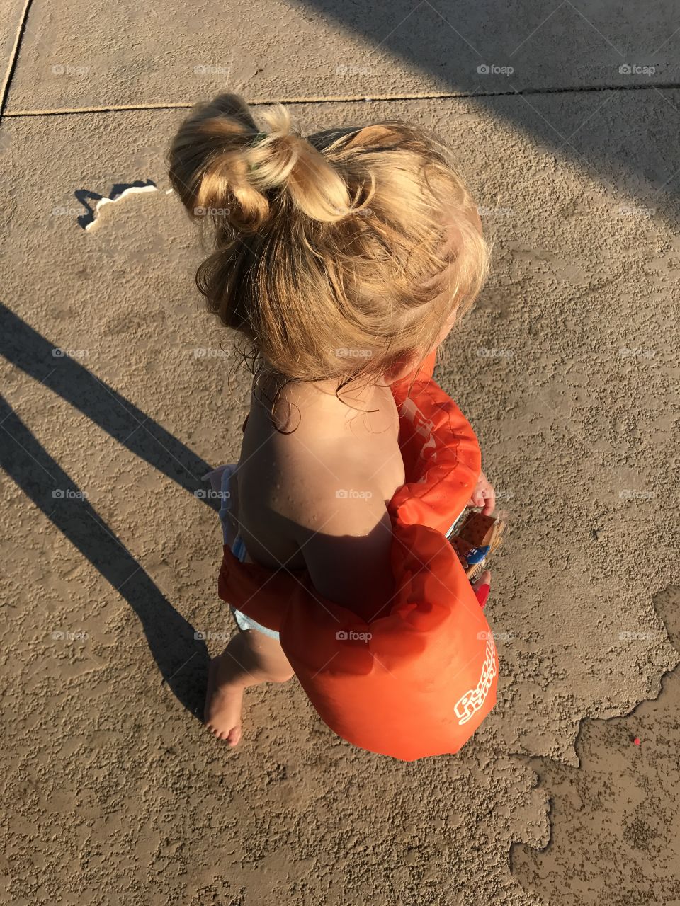 Girl wearing life jacket at pool