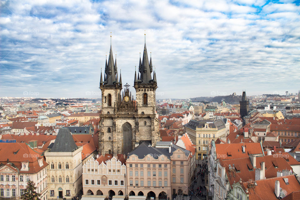 Church in the Old Town Square in Prague. The sky is sunny and full of clouds.