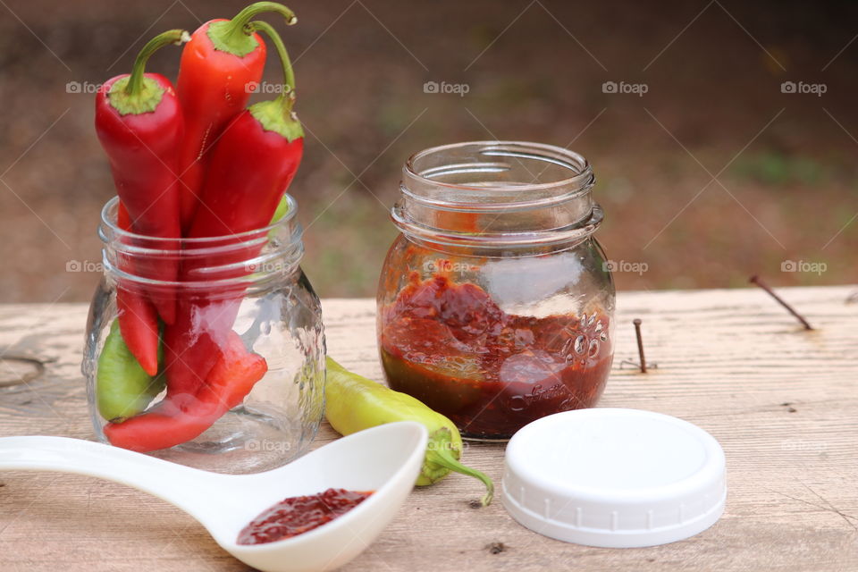 Farm fresh red pepper preserves; rustic outdoor image 