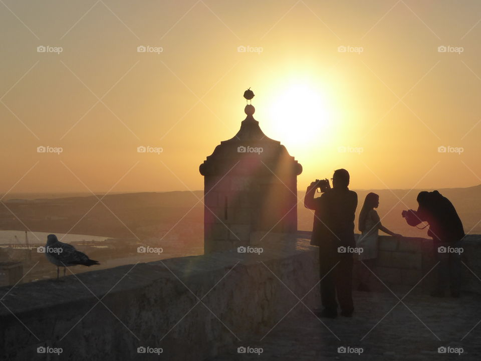 Silhouette of peoples at coastline