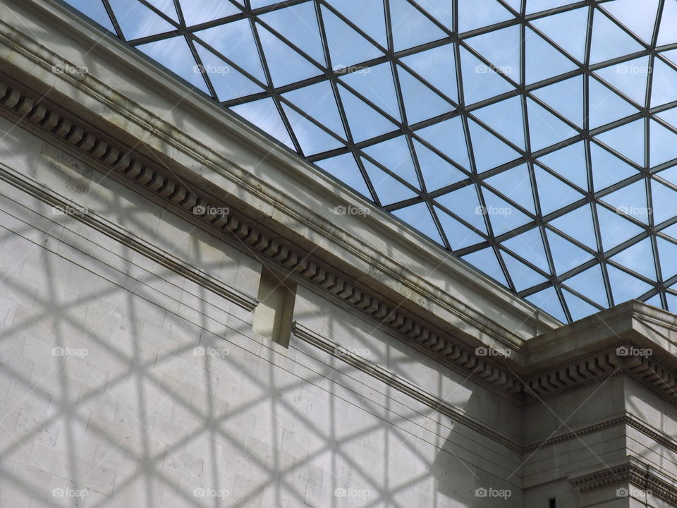 Glas roof of the British museum in London on a sunny day with bright blue sky.