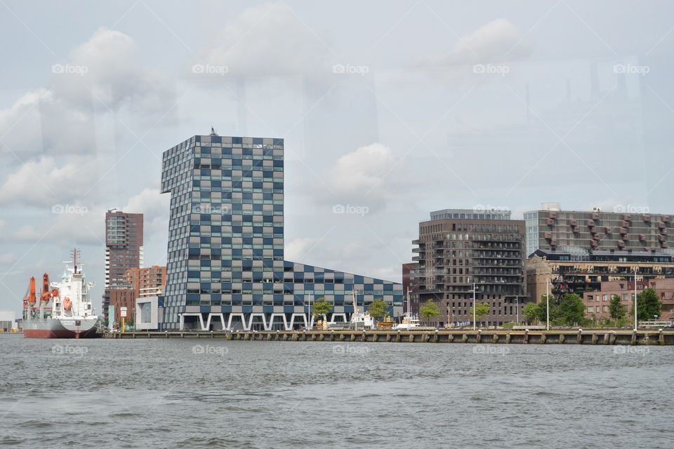A waterway in Rotterdam Loydkwartier. With a small skyscraper. 
