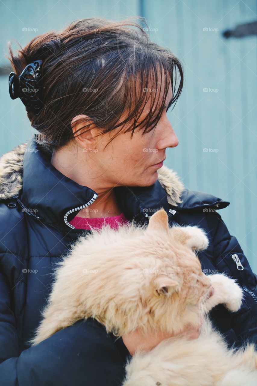 A woman holding a cat