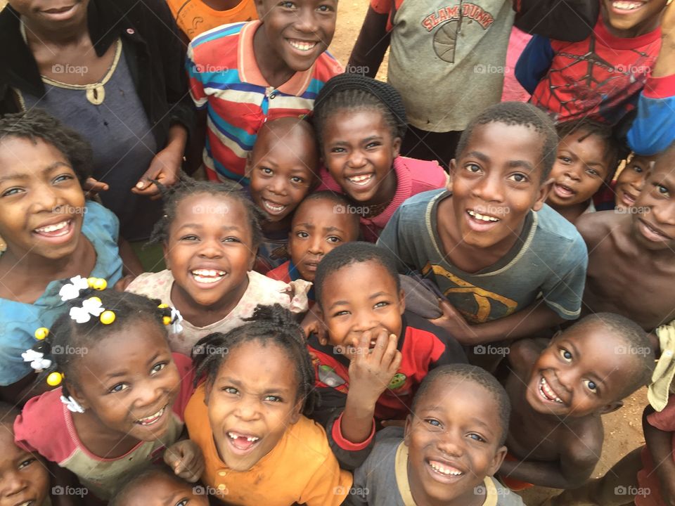 The Haitian Happy. A crowd of children gather to have their picture taken. For some it is the first time they have seen their bright smiles