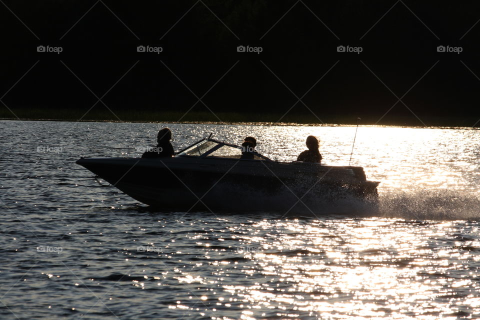 Riding motorboat in a sunset