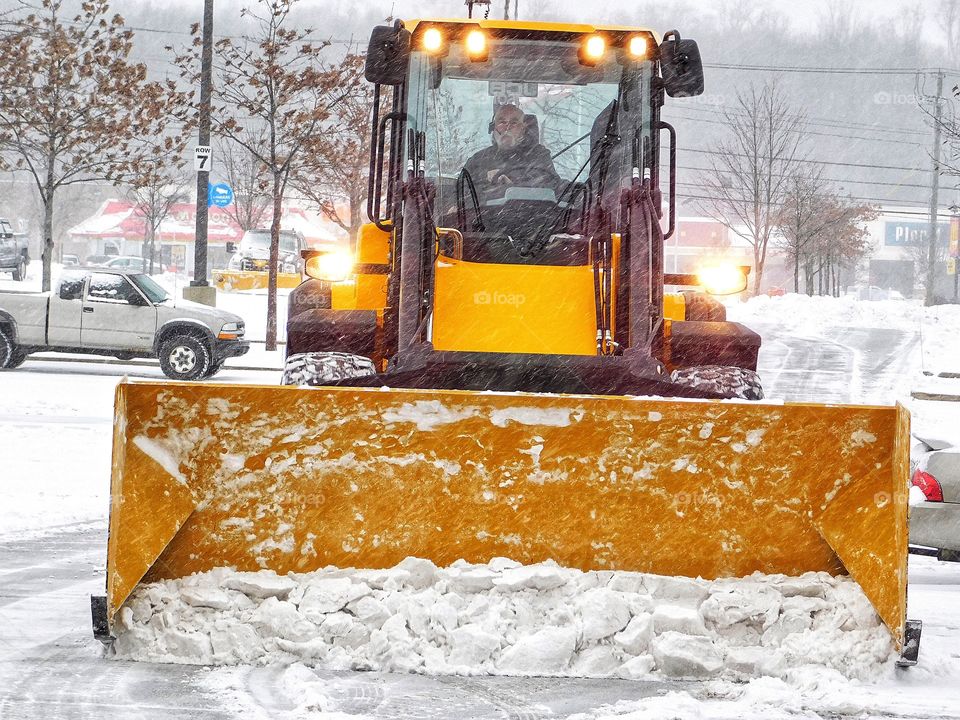 It’s snowing! Parking lot snow plow...