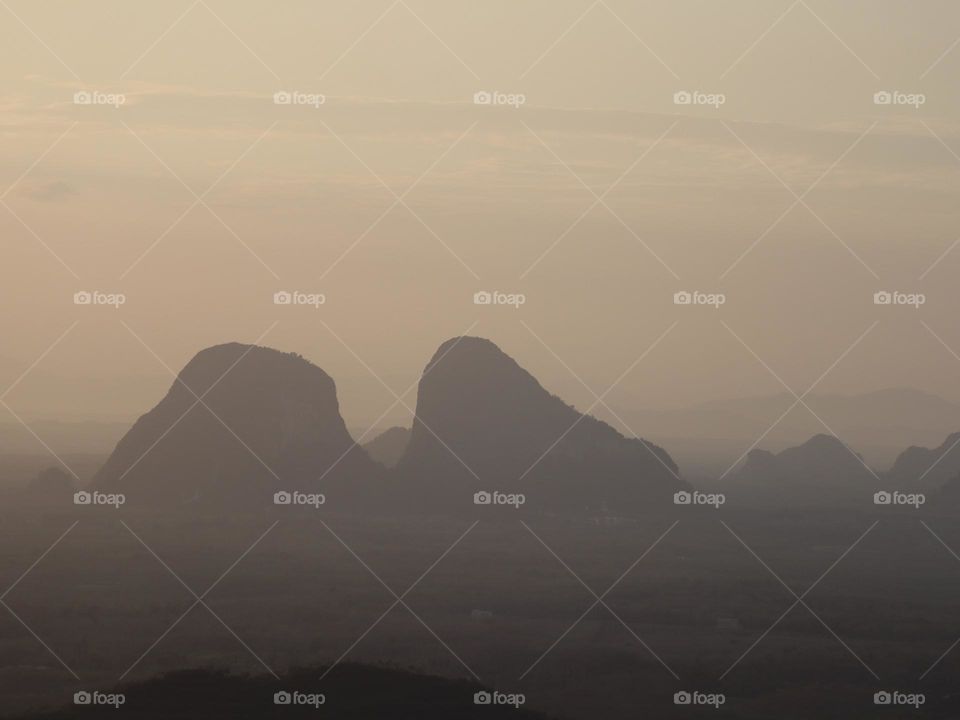 Scenic view of mountains covered with fog early in the morning