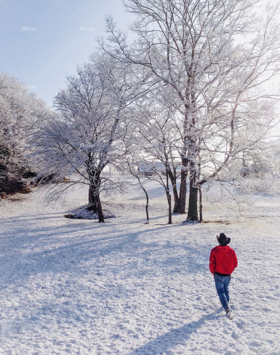 Man jacket cowboy hat walking in the snow