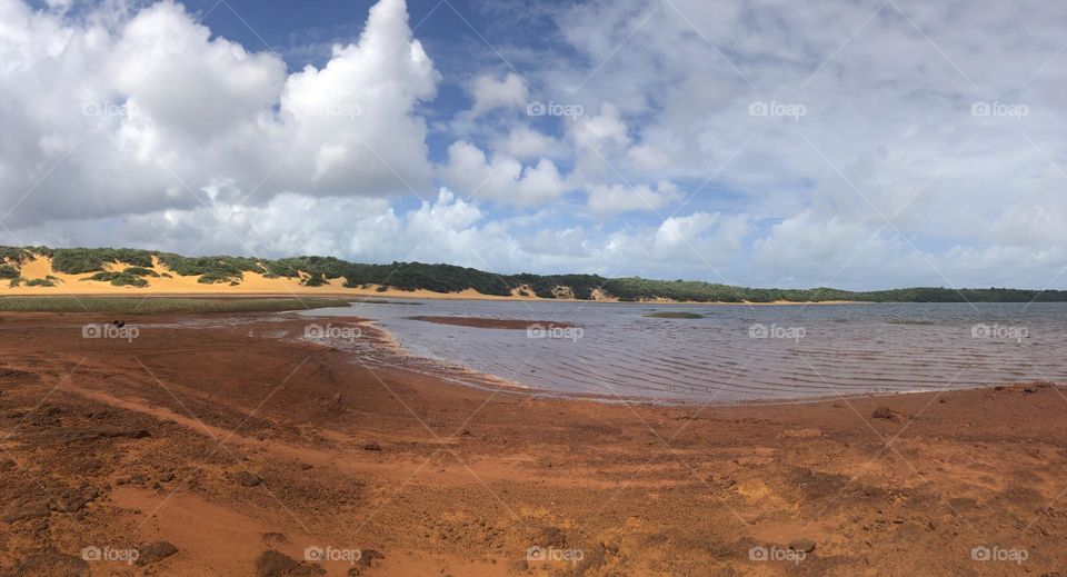 Lake surrounded by a red sand in tropical area