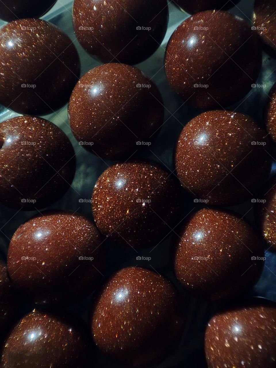 Macro photograph of a natural aventurine stone lying on a table