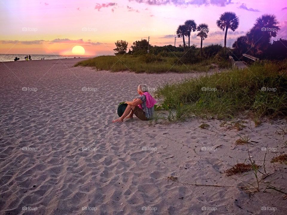 Lady watching the sun set. Lady watching the sun set