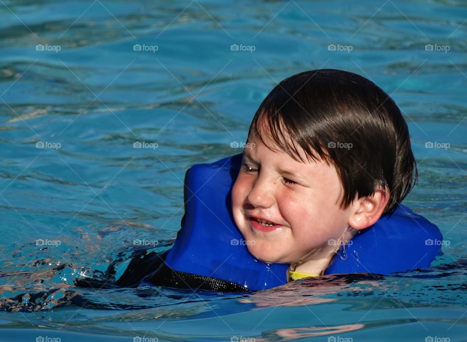 Young Swimmer. Young Boy Learning To Swim
