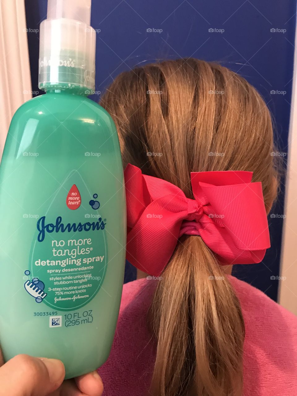 Johnson and Johnson no more tears hair product. Girl with pink hair bow and ponytail. 