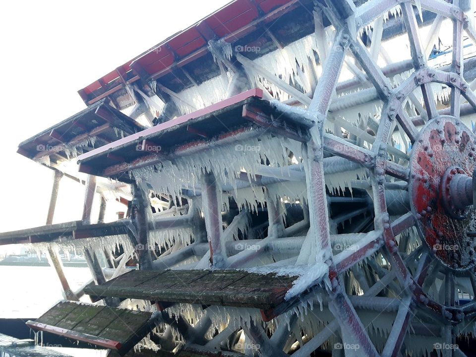 Icicles on the paddle wheel of a steamer in the frosty cold