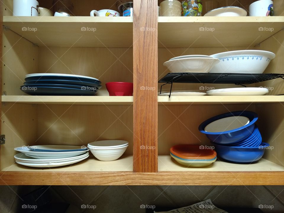 Chaos in the cabinet. Can you spot what's wrong? Teaching kids how to put dishes away.