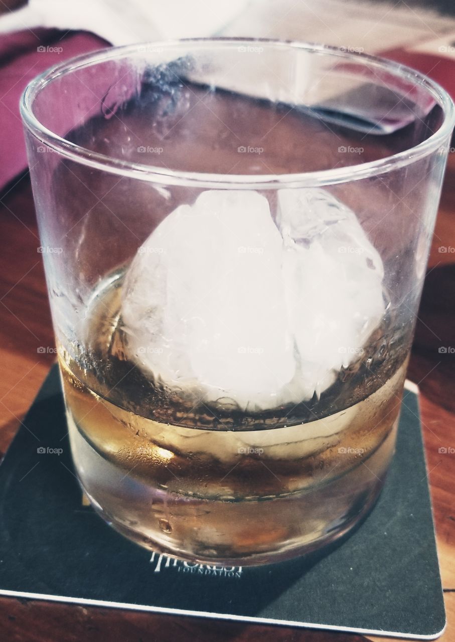 Ice ball for chilled whiskey days, pinkie out, drinks up at scenic Twin Peaks, Concord NC.