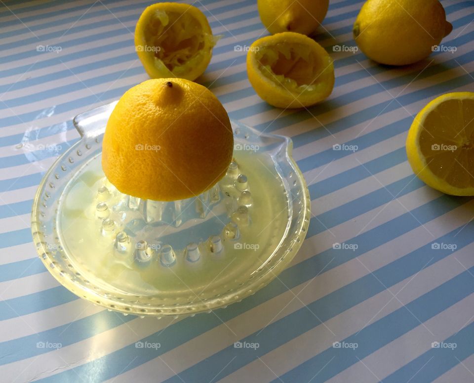 Squeezing juice out of lemons to make homemade lemonade 