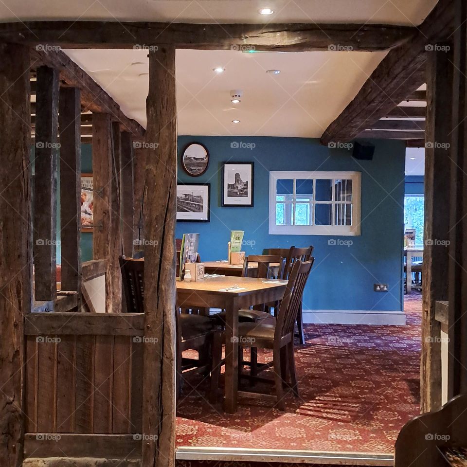 dinning area in restaurant u.k blue and dark wooden frame table chairs