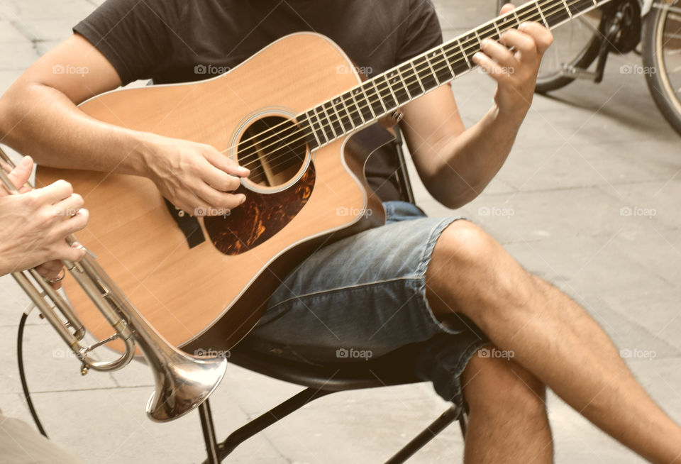 Playing the guitar in the middle of the street