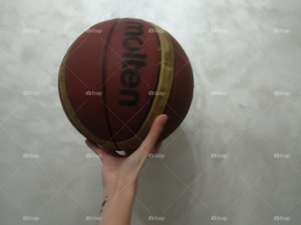 a hand holding a ball.