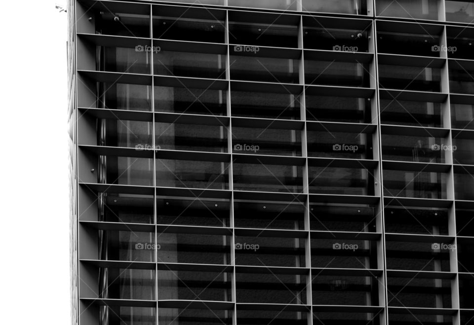 Monochrome low angle view of building exterior against sky.