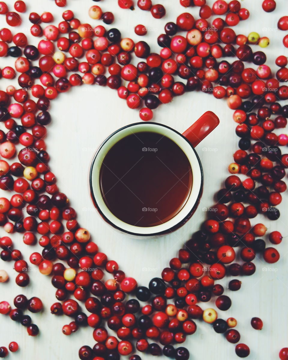 Cranberries in the shape of a heart with tea