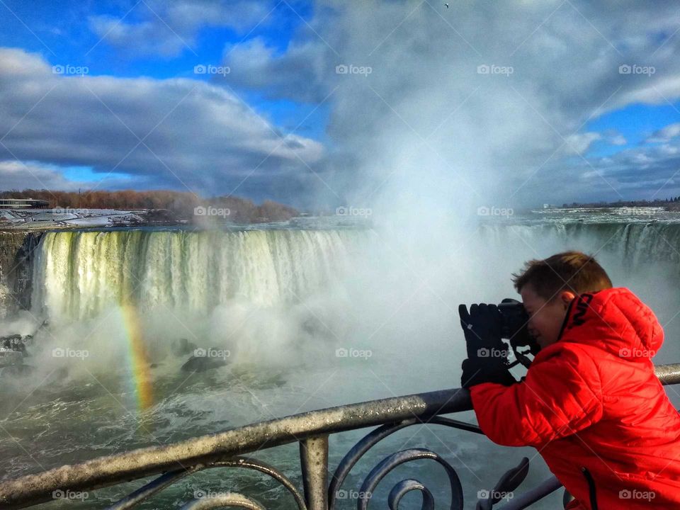 young boy photographs Niagara Falls